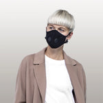 A light-skinned person wearing the Airinum Urban Air Face Mask 2.0 in black.