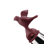 Maroon colored, dimensional, bird-shaped kettle whistle.