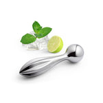 Mirror-polished object shown next to ice cubes, a sprig of mint and a half lime.