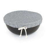A medium sized grey cloth with tied draw string shown covering a bowl.