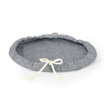 A medium size Plat Bowl Cover with draw string tied shown laying flat.