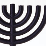 A zoomed in shot of the Menorah showing the rough texture of the cast iron.