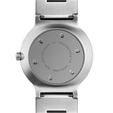 Back of watch face with engraved letters that include the product number, material, and water resistant.