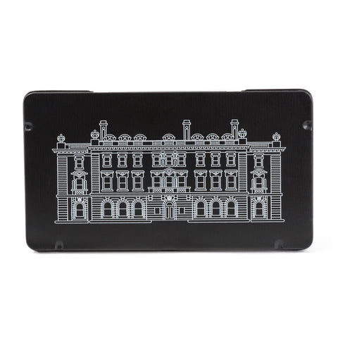 Facing forward, the front on a rectangular black tin has the Cooper Hewitt mansion printed in white outline.