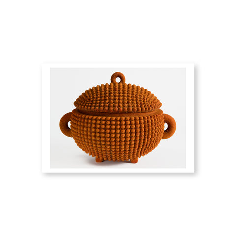 A reddish brown textured bowl with a lid, three circular handles and feet.