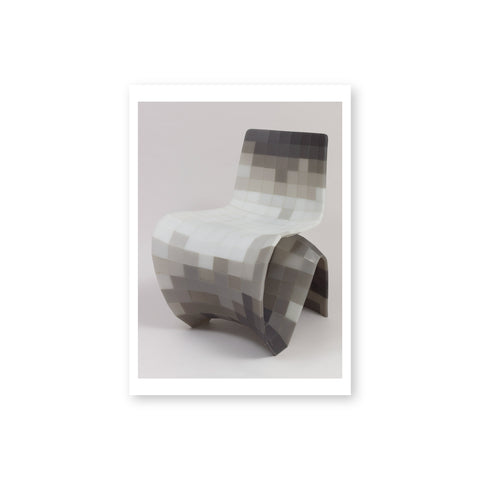Postcard of uniquely shaped chair with a pattern made up of many white, gray, and black squares (pixels), creating a gradient effect.  