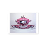 A pink glazed rococo-style porcelain soup tureen with an embellished cover sits on a coordinating pink stand. Overlaying the pink background is a branch and leaf motif painted in black and platinum. The front center of the tureen features a photo transferred  image of Cindy Sherman dressed as Madame de Pompadour. Two additional photo transfers are printed on either sIde of the stand. 