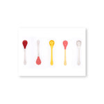 A horizontal postcard with a white border features a row of six, evenly spaced translucent spoons in clear or yellow, with round, textured bowls with or without a reddish coating, and easy-to-grip handles. 