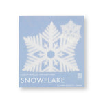 A lacy paper snowflake shows through clear packaging with a light blue cardboard backing.