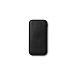 Black, rectangular Carry charger with rounded corners, a pebbled texture, and three vertically aligned charging dots in the middle.