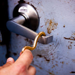 Sigma tool in use to open a door handle by hooking its end around the lever to pull down "hands free".