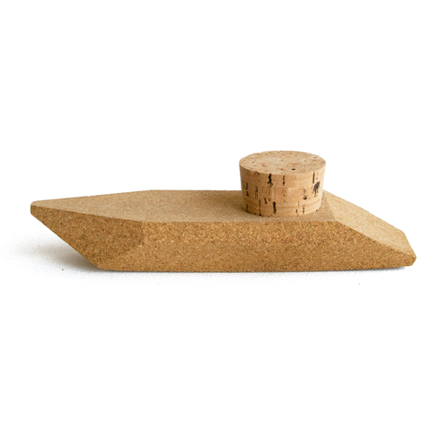 Mini speedboat made out of cork. A removable cork stopper is inserted into the top of the boat.