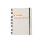 Classic rectangular notebook in gray with a black metal spiral on the left and a black elastic strap on the right. Manufacturers name, logo and 2 lines of neatly spaced text appear 1/3 from the top in orange sans serif letters.