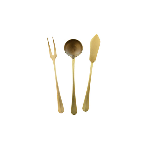 Three brass serving utensils; fork with two tines, shallow spoon, and a small knife. 