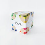 A white cube package with graphic depictions of bocce balls on each corner.