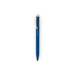 Navy blue pen with gold clip and end cap. The tip is retracted, and the metal slide on the face-forward side indicates with a colored circle that the ink will be blue.