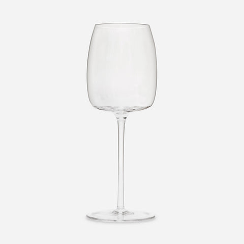 Single wine glass with a standard base, delicate stem, and slightly flat-bottomed, tulip-shaped bowl.
