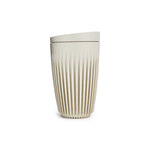 A tall, beige-colored reusable cup with a flat bottom, tapering shape and overall  pattern of tight vertical ribs, indented towards the base. With a flat, wedge-shaped lid.