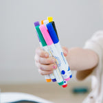 A child's fistful of markers.