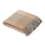 Beige checkered throw with fringe tips.