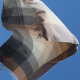 Checkered throw with fringe tips in an array of neutral colors