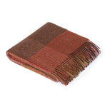 Red checkered throw with fringe tips.