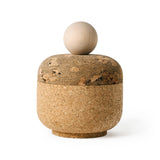 Squircle shaped container with a marbled cork lid, cork bottom, and sphere-shaped maple wood handle, shot on a white background.