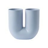 A light blue tubular vase in the shape of a "U" with two separate openings.
