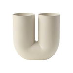 A cream colored tubular vase in the shape of a "U" with two separate openings.