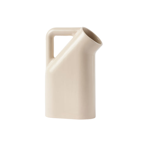 A cream colored  jug with smooth rounded corners, a wide round mouth and tubular handle.