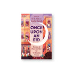 Once Upon an Eid book cover featuring a warm illustration of two three story buildings covered in celebration decorations with people leaning out of the windows. A large crescent moon at the center of the illustration cups the title text.