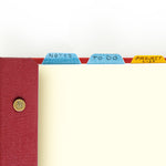 Three fabric tabs being used in a red letter-sized snap pad