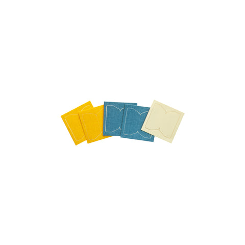 Five pressed cotton fabric tabs in yellow, blue, and white