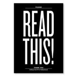 The front of a notebook has the text "READ THIS!" printed in white extra large font on a solid black background.