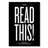 The front of a notebook has the text "READ THIS!" printed in white extra large font on a solid black background.