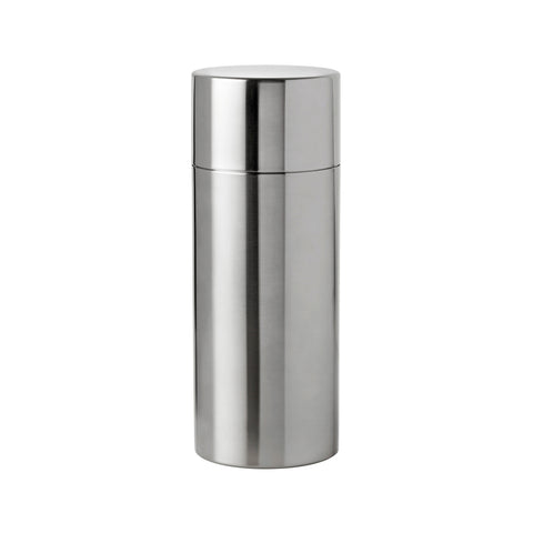 Cylindrical, steel cocktail shaker made of two separate pieces, the body longer than the top. Sides are straight and top and bottom are flat.