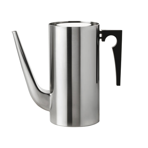 Cylindrical steel vessel with a long, trunk-like spout curving up from the bottom of the vessel. It has a flat top with space around the edge, and a black handle. Handle's outside edge is a right angle and the inside edge is a curve with a circle cut into it.