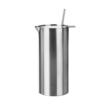 Tall, cylindrical steel martini mixer with a small spout at the top edge, and flat lid that has a mixer protruding from a small opening and a narrow protrusion for flipping the lid open.. 