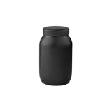 Sleek, matte black ground coffee storage jar with matching lid.