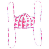 White face mask with long side ties, printed with repeating rows of vibrant pink triangles.