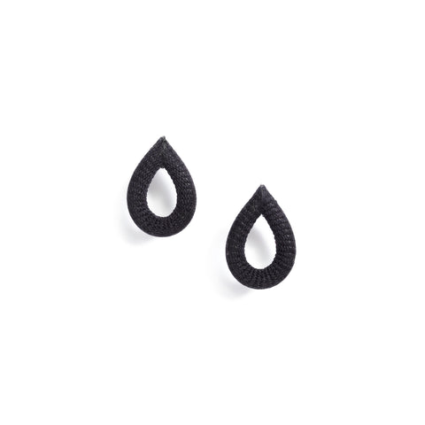 The Loop Earrings, each a black, textured open teardrop.