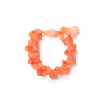 Several white/ translucent silicone beads incased in a vibrant orange lace form a choker with a loop closure