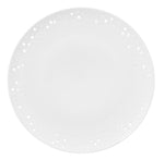 White, wafer-thin saucer on a white background, glazed porcelain with irregularly pierced edges inspired by the sensuous appearance of sun-bleached coral.