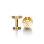 A pair of solid brass cufflinks. The brand's logo is etched into th base of the cufflink.