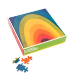 Colorful box showing a rainbow of curved bands on top with red and green sides and a yellow base. Five blue and orange puzzle pieces sown outside box some interlocked