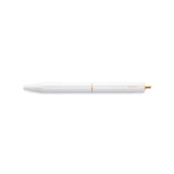 The White Brassing Portable Ball Point Pen has flat sides for grip, a brass-colored scalloped center seam, a small, brass-colored, ystudio logo, and a narrow, brass end.